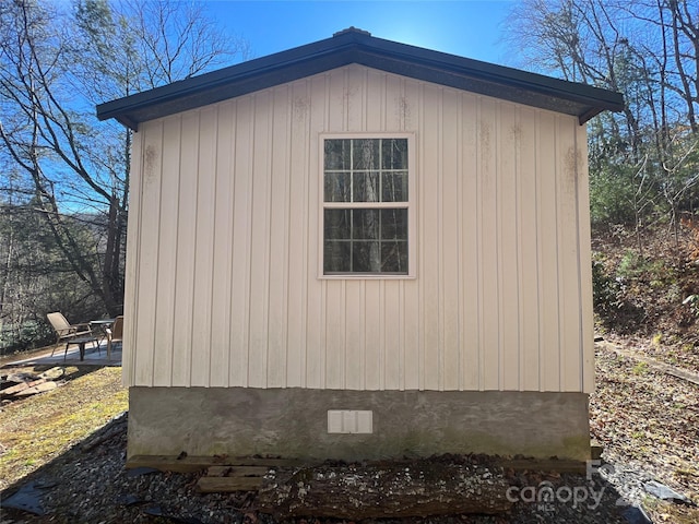 view of home's exterior featuring an outbuilding, crawl space, and a storage shed