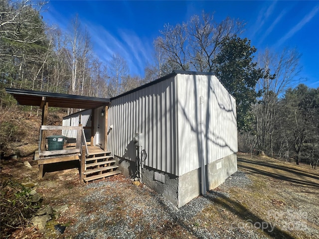 view of side of home with a deck and crawl space