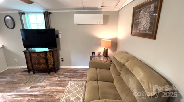 living room with ornamental molding, a wall mounted air conditioner, baseboards, and wood finished floors