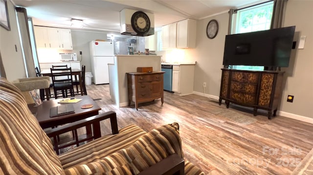 living area with light wood-style flooring and baseboards