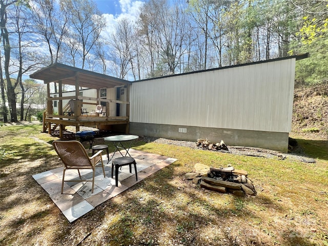 1019 Hudlin Gap Rd, Pisgah Forest, NC 28768 - view of yard with a wooden deck, a patio, and an outdoor fire pit