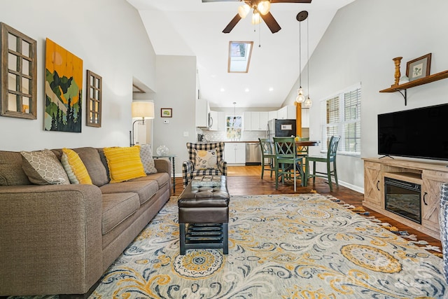 living room with high vaulted ceiling, baseboards, a ceiling fan, and dark wood-style flooring