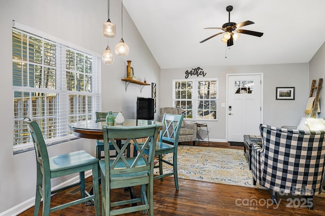 dining room featuring ceiling fan, vaulted ceiling, baseboards, and wood finished floors