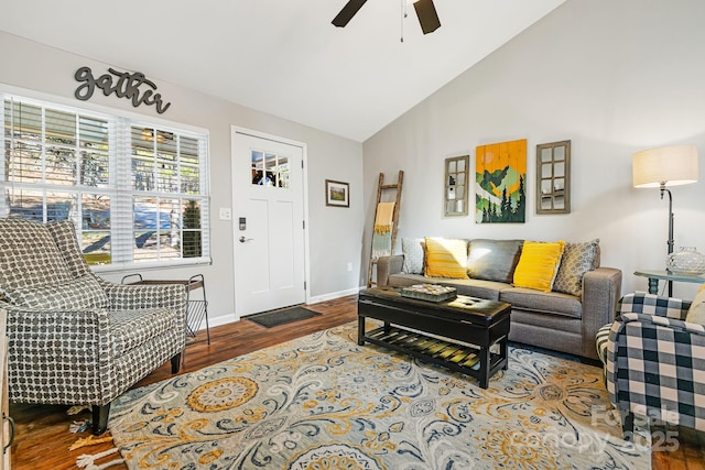 living room featuring vaulted ceiling, wood finished floors, a ceiling fan, and baseboards