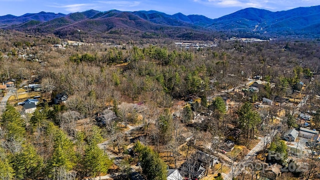 aerial view with a wooded view and a mountain view