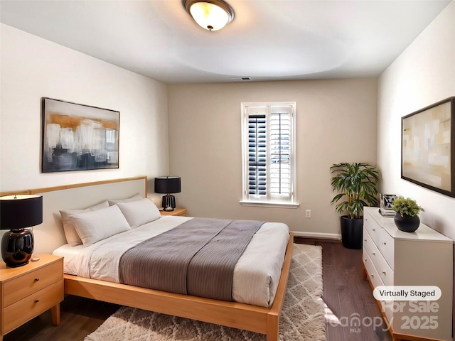 bedroom featuring dark wood-style flooring, visible vents, and baseboards