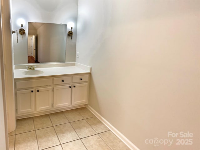 bathroom with tile patterned flooring, vanity, and baseboards