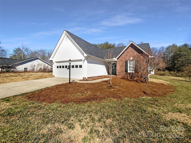 view of front of home featuring a garage, driveway, brick siding, and a front lawn