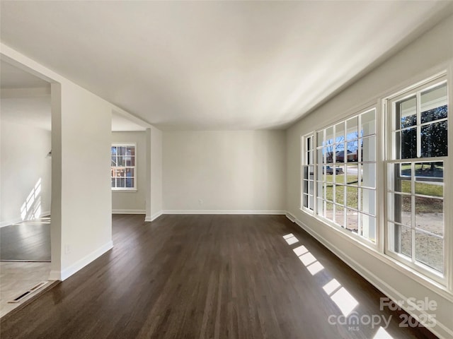 unfurnished room featuring dark wood finished floors and baseboards