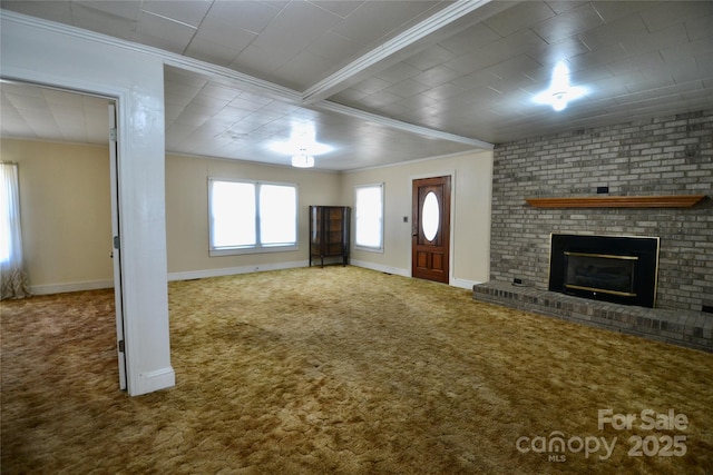 unfurnished living room with carpet, a fireplace, baseboards, and crown molding