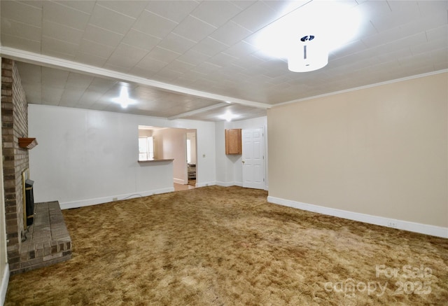 unfurnished living room with carpet floors, a brick fireplace, and baseboards