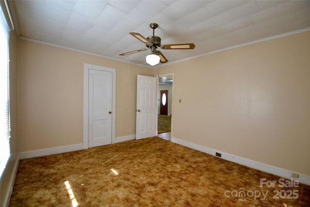 unfurnished bedroom featuring baseboards, ceiling fan, carpet flooring, and crown molding