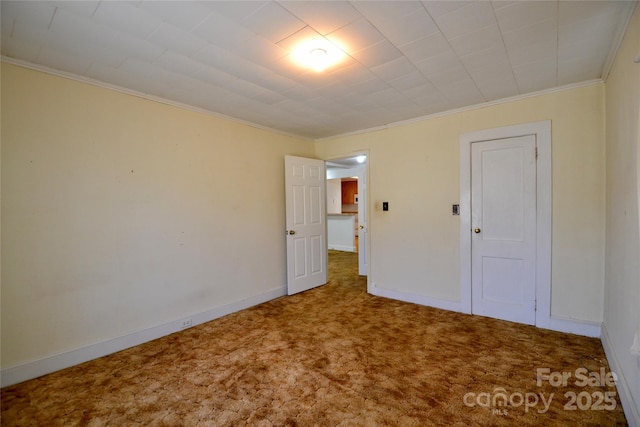 unfurnished bedroom with carpet floors, ornamental molding, and baseboards