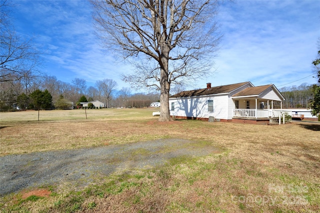 view of yard featuring covered porch