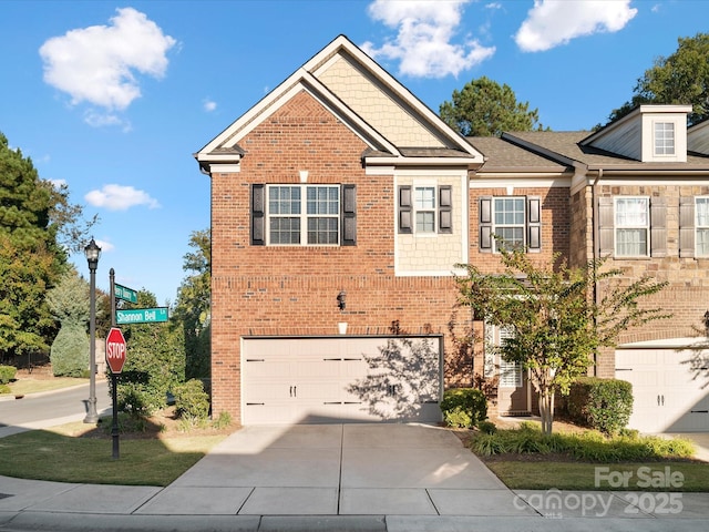 view of front facade featuring concrete driveway, brick siding, and an attached garage