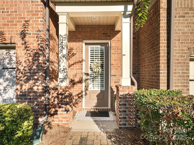 property entrance with brick siding