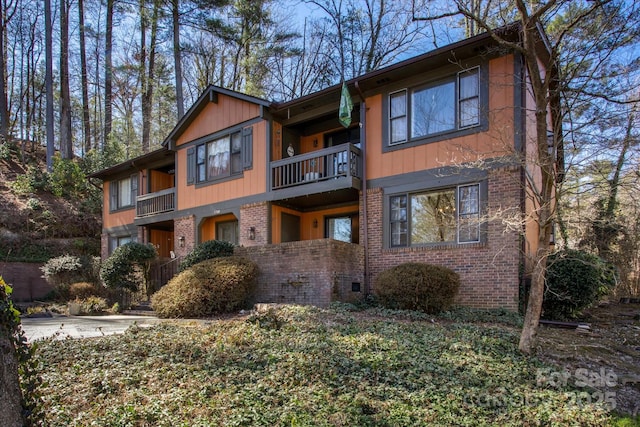 view of front of property featuring brick siding, crawl space, and an attached garage