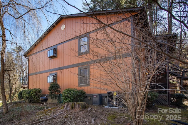 view of side of home with central air condition unit