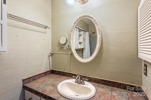 bathroom with vanity and tile walls