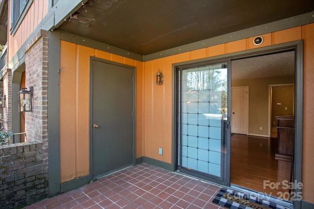 property entrance with brick siding