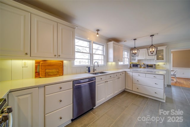 kitchen featuring a peninsula, a sink, light countertops, dishwasher, and tasteful backsplash