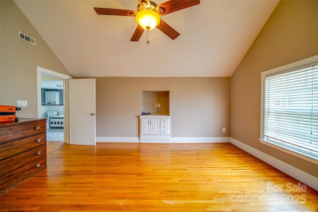 unfurnished living room featuring lofted ceiling, a ceiling fan, baseboards, visible vents, and light wood-style floors