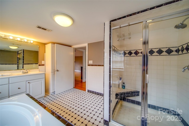 full bath featuring a stall shower, visible vents, and vanity