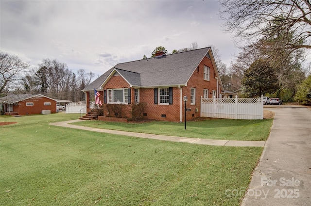 view of front of house with brick siding, a shingled roof, fence, crawl space, and a front lawn