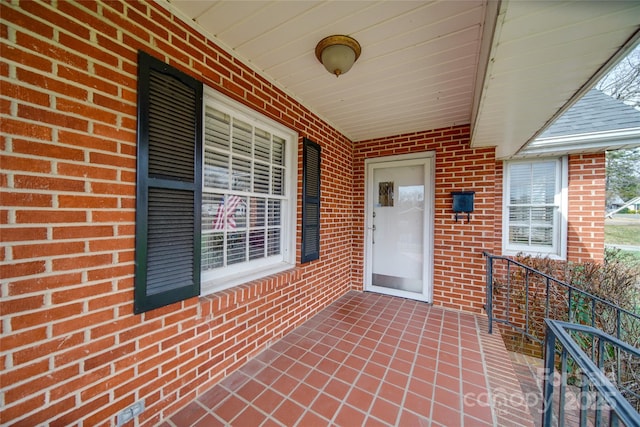 property entrance featuring brick siding