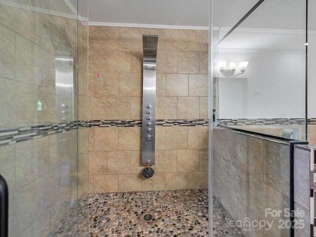 bathroom with ornamental molding and a shower stall