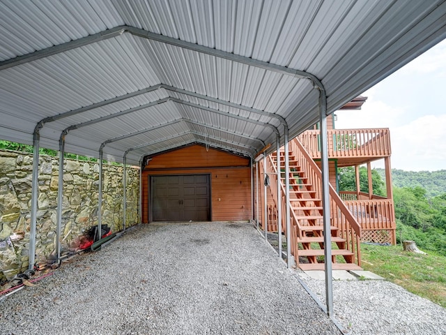 exterior space featuring a garage, stairway, and a carport