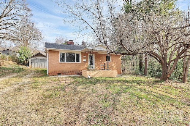 view of front of home featuring brick siding, roof with shingles, a chimney, crawl space, and a front lawn