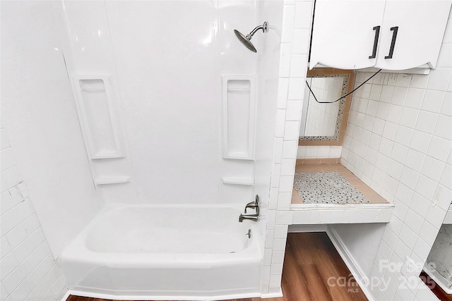 full bathroom with tile walls and bathing tub / shower combination