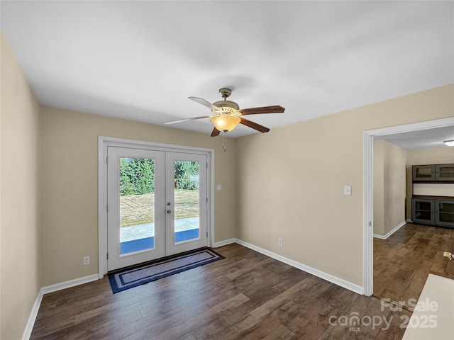 interior space featuring ceiling fan, baseboards, dark wood-style flooring, and french doors