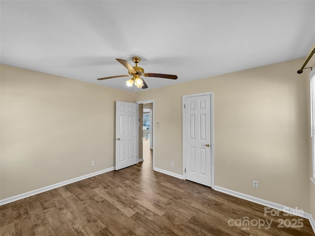 unfurnished bedroom with wood finished floors, a ceiling fan, and baseboards