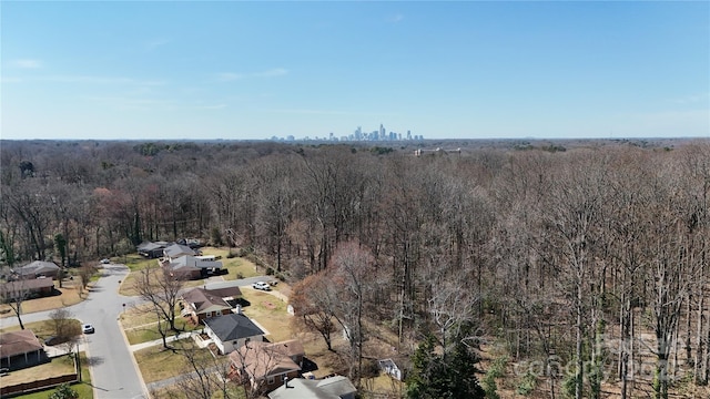 bird's eye view with a wooded view