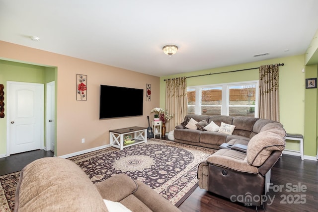 living room featuring dark wood-style floors, visible vents, and baseboards