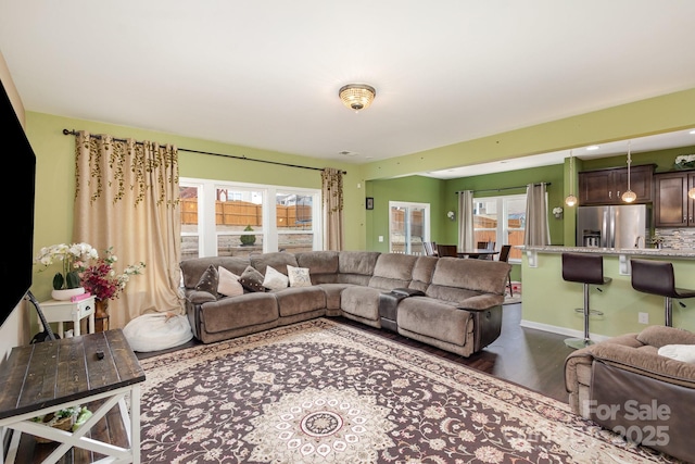 living room with dark wood-style floors and baseboards