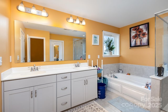 full bath featuring a stall shower, a garden tub, a sink, and double vanity