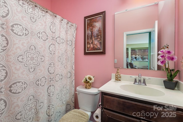 bathroom with toilet and vanity