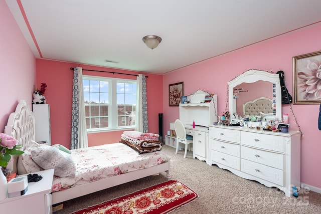 carpeted bedroom featuring visible vents