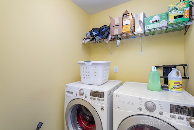 clothes washing area featuring washer and dryer and laundry area