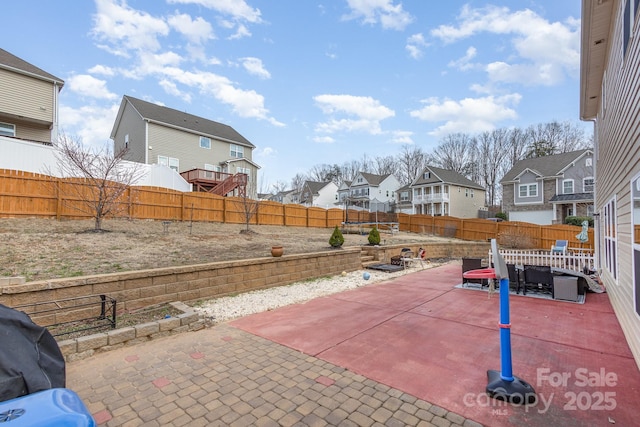 view of patio / terrace featuring a residential view and a fenced backyard