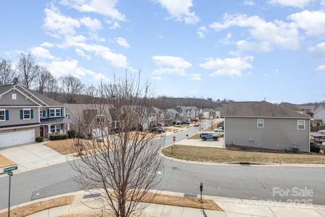 view of road featuring sidewalks, a residential view, and curbs