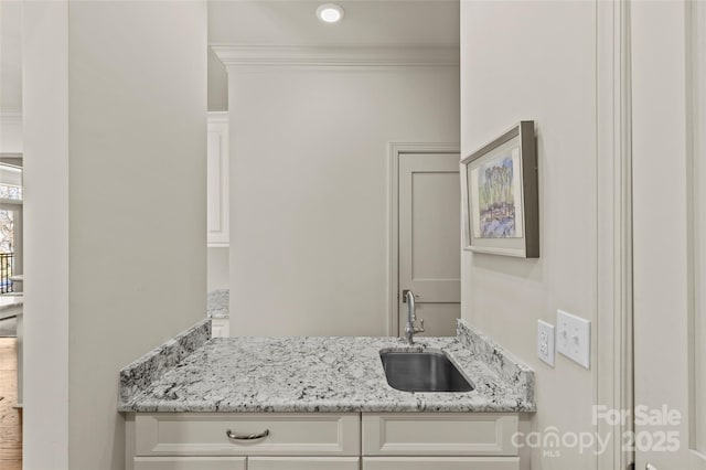 bathroom featuring ornamental molding, recessed lighting, and vanity