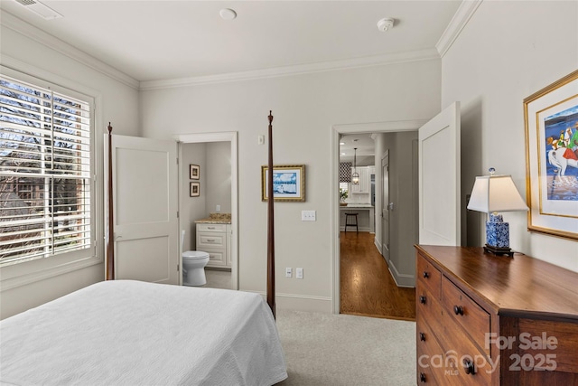 bedroom with ornamental molding, multiple windows, visible vents, and baseboards