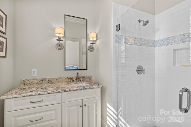 bathroom featuring a shower stall and vanity