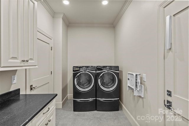 clothes washing area with recessed lighting, baseboards, cabinet space, washing machine and clothes dryer, and crown molding