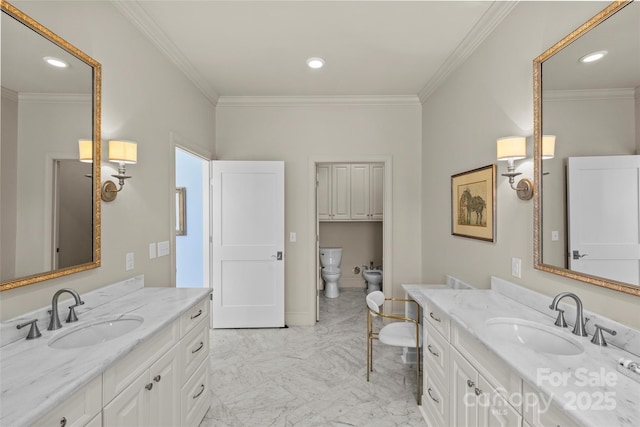 bathroom with marble finish floor, crown molding, a bidet, and a sink