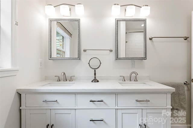 bathroom featuring a sink and double vanity